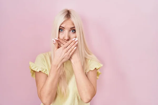 Caucasian Woman Standing Pink Background Shocked Covering Mouth Hands Mistake — Stok fotoğraf