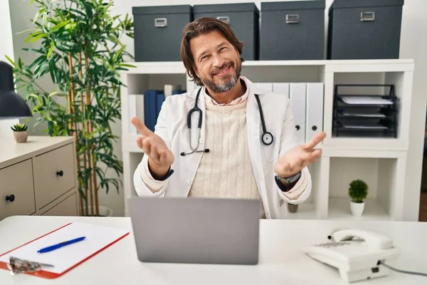 Handsome Middle Age Doctor Man Working Clinic Smiling Cheerful Offering — ストック写真