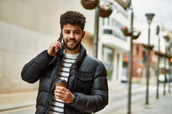 Young arab man speaking on the phone outdoor at the town