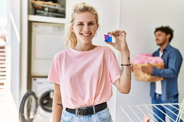 Young Couple Doing Laundry Woman Smiling Happy Holding Detergent Home — Fotografia de Stock