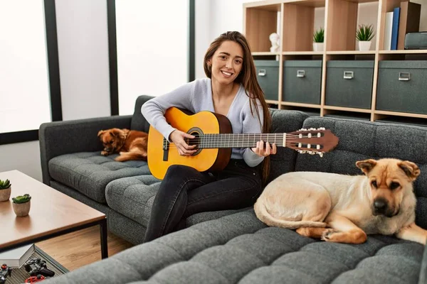 Jovem Hispânica Tocando Guitarra Clássica Sentada Sofá Com Cães Casa — Fotografia de Stock