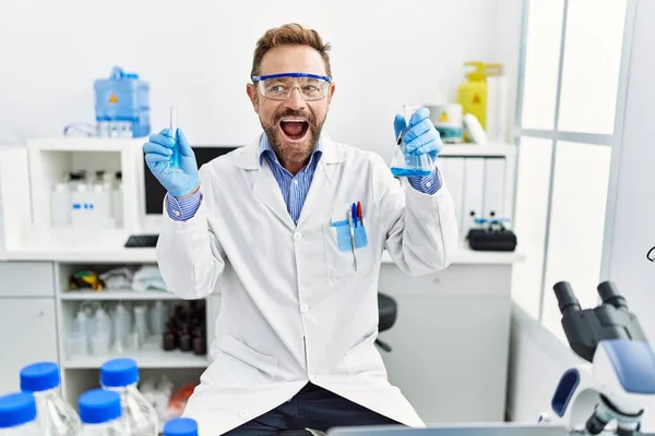 Middle Age Man Working Scientist Laboratory Holding Chemical Products Smiling — 图库照片