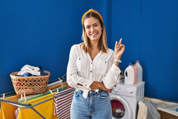 Young Blonde Woman Laundry Room Big Smile Face Pointing Hand — 图库照片