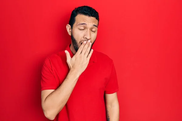 Latynos Brodą Czerwonej Koszuli Znudzony Ziewaniem Zmęczonym Zakrywaniem Ust Dłonią — Zdjęcie stockowe