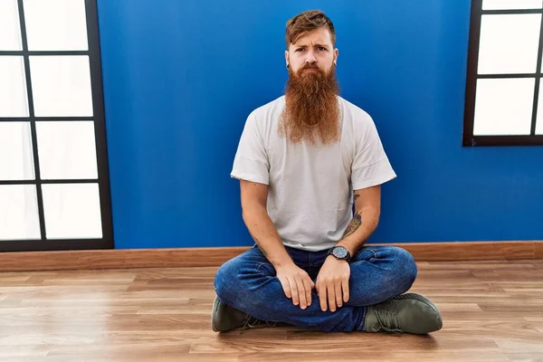 Redhead Man Long Beard Sitting Floor Empty Room Depressed Worry — Stockfoto