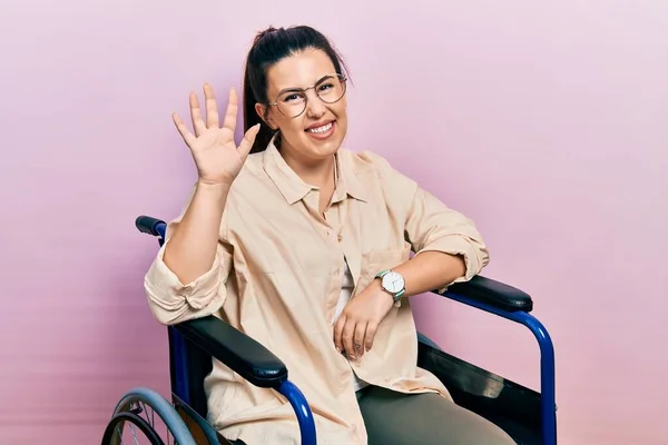 Young Hispanic Woman Sitting Wheelchair Waiving Saying Hello Happy Smiling — ストック写真