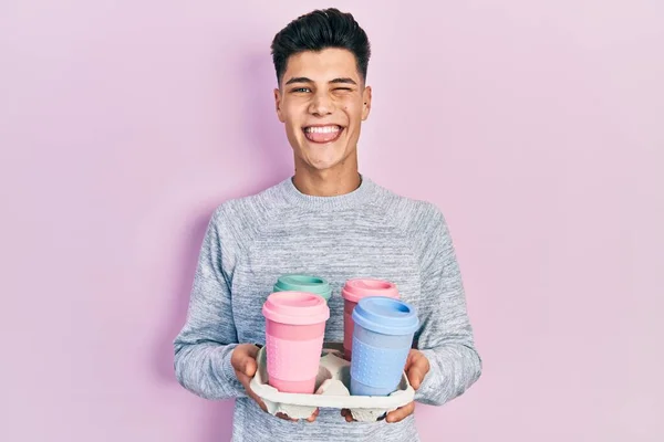 Young Hispanic Man Holding Tray Take Away Coffee Sticking Tongue — Stock Fotó