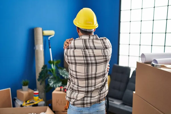 Young Hispanic Man Beard Working Home Renovation Hugging Oneself Happy — Fotografia de Stock