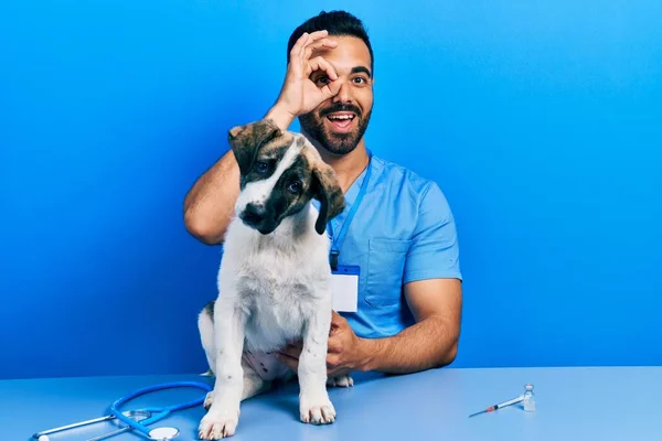 Handsome Hispanic Veterinary Man Beard Checking Dog Health Doing Gesture — Foto Stock