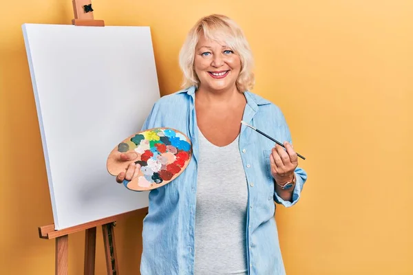 Middle Age Blonde Woman Standing Drawing Palette Painter Easel Stand — Stock Photo, Image