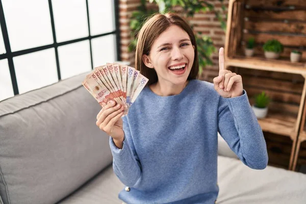 Young Brunette Woman Holding Colombian Pesos Surprised Idea Question Pointing — Fotografia de Stock