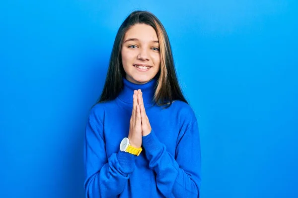 Young Brunette Girl Wearing Turtleneck Sweater Praying Hands Together Asking — Stockfoto