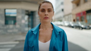 Sokakta duran rahat yüzlü genç kadın.