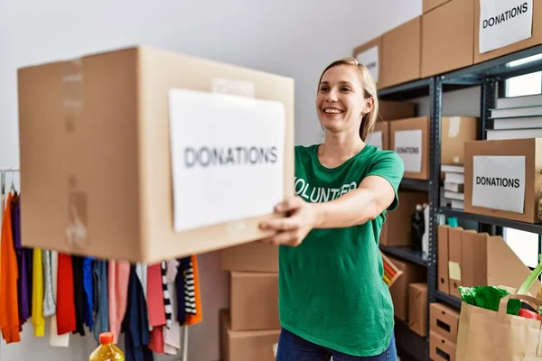 Gönüllü Üniformalı Beyaz Bir Kadın Bağış Paketiyle Yardım Merkezinde Çalışıyor — Stok fotoğraf