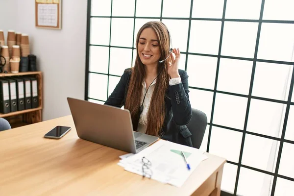 Young hispanic woman call center agent having video call working at office