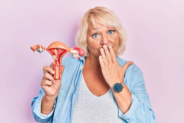 Middle Age Blonde Woman Holding Anatomical Model Female Genital Organ — Foto de Stock