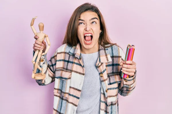 Young Caucasian Girl Holding Small Wooden Manikin Pencils Angry Mad — Fotografia de Stock