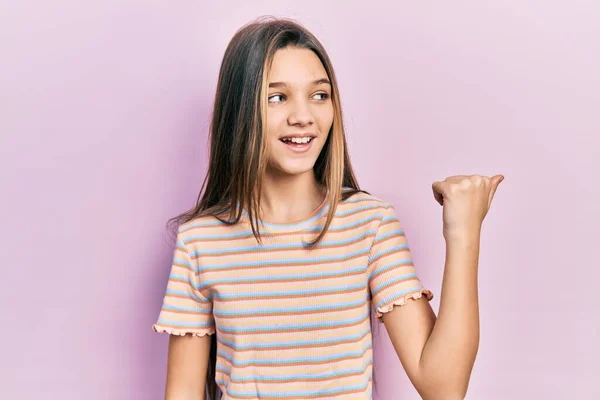 Young Brunette Girl Wearing Casual Striped Shirt Pointing Thumb Side — Stock Photo, Image