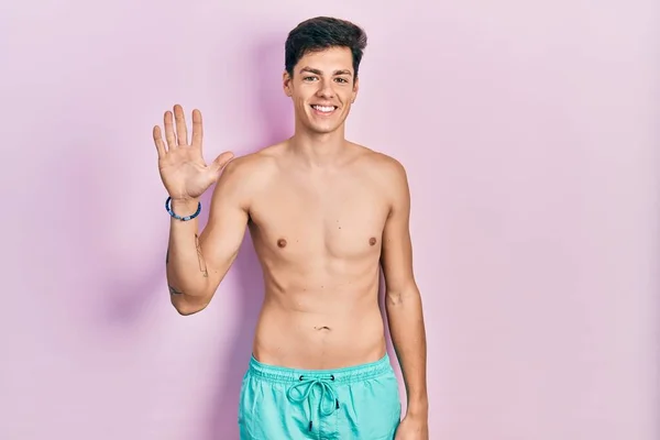 Young Hispanic Man Wearing Swimwear Shirtless Showing Pointing Fingers Number — Stock Photo, Image