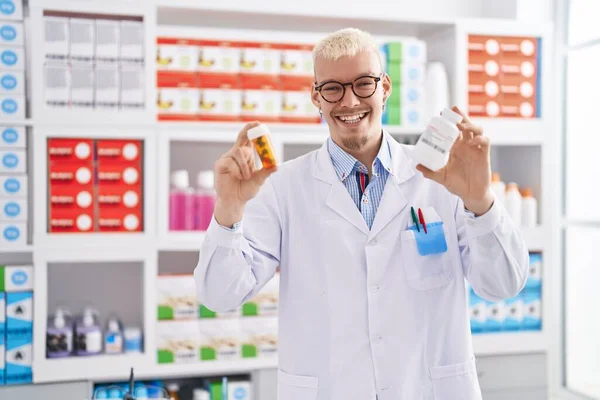 Young Caucasian Man Pharmacist Holding Pills Bottles Pharmacy — Foto Stock
