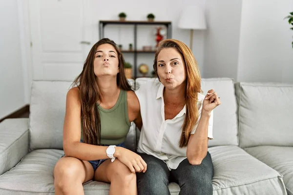 Mother Daughter Together Sitting Sofa Home Looking Camera Blowing Kiss — Stok fotoğraf