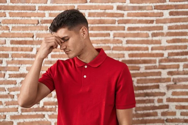 Young Hispanic Man Standing Bricks Wall Tired Rubbing Nose Eyes —  Fotos de Stock