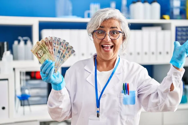 Middle Age Woman Grey Hair Working Scientist Laboratory Holding Polish — Stok fotoğraf