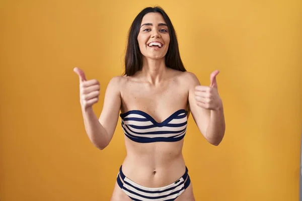 Young Brunette Woman Wearing Bikini Yellow Background Success Sign Doing — ストック写真