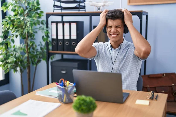Young Hispanic Man Working Office Wearing Headphones Suffering Headache Desperate — 图库照片