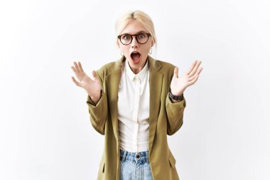 Beautiful caucasian business woman standing over isolated background celebrating crazy and amazed for success with arms raised and open eyes screaming excited. winner concept 