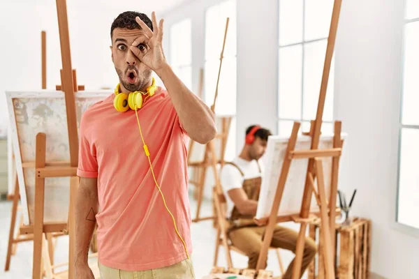 Young Hispanic Man Art Studio Doing Gesture Shocked Surprised Face — Stockfoto
