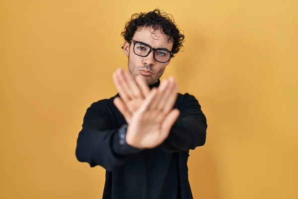 Hispanic Man Standing Yellow Background Rejection Expression Crossing Arms Palms — ストック写真