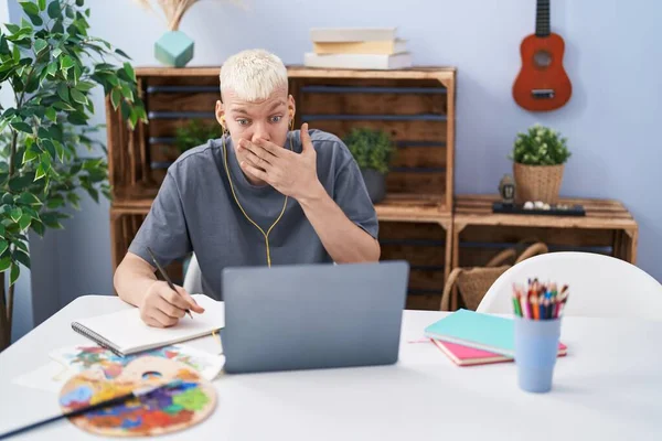 Young Caucasian Man Drawing Doing Video Call Laptop Covering Mouth — Stockfoto