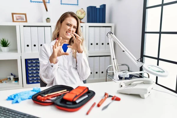 Young Beautiful Doctor Woman Reflex Hammer Medical Instruments Disgusted Expression — Stock Photo, Image