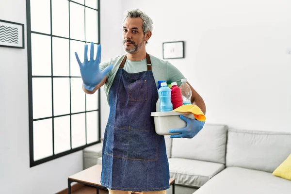 Middle Age Hispanic Man Wearing Cleaner Apron Holding Cleaning Products — Stock Photo, Image