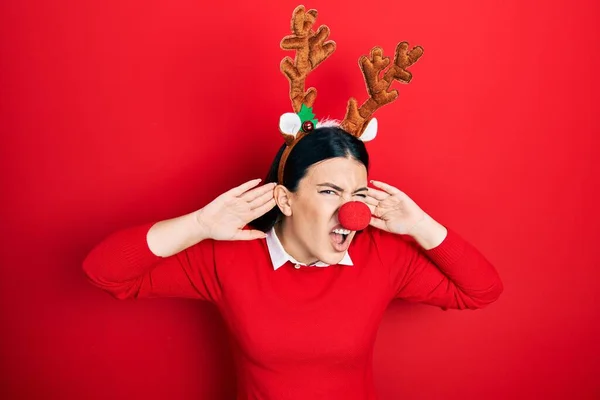 Young Hispanic Woman Wearing Deer Christmas Hat Red Nose Trying —  Fotos de Stock