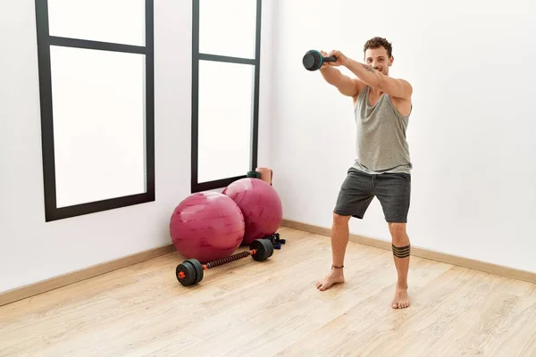 Giovane Uomo Ispanico Sorridente Allenamento Fiducioso Utilizzando Kettlebell Centro Sportivo — Foto Stock