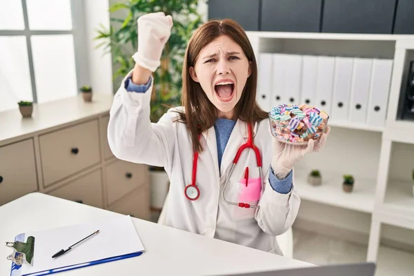Young Doctor Woman Holding Sweets Candy Annoyed Frustrated Shouting Anger — ストック写真