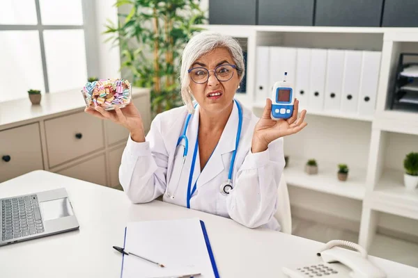 Middle Age Woman Grey Hair Wearing Doctor Uniform Holding Glucose — Stockfoto