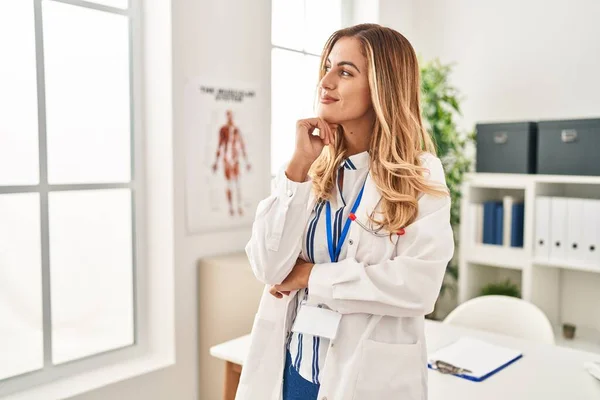 stock image Young blonde woman wearing doctor uniform standing with arms crossed gesture at clinic