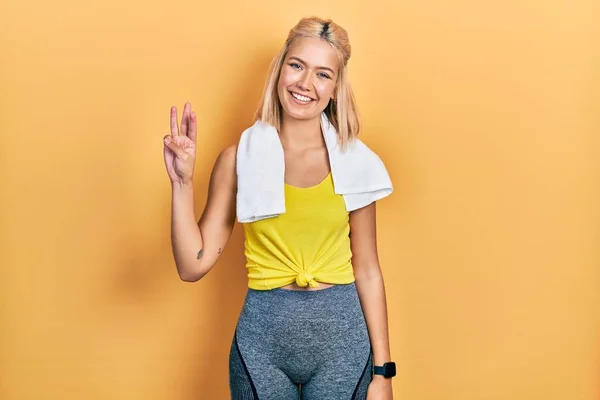 Beautiful Blonde Sports Woman Wearing Workout Outfit Showing Pointing Fingers — Stockfoto