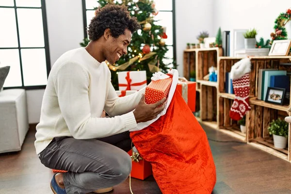 Young African American Man Holding Gifts Santa Claus Bag Home — Stock Photo, Image