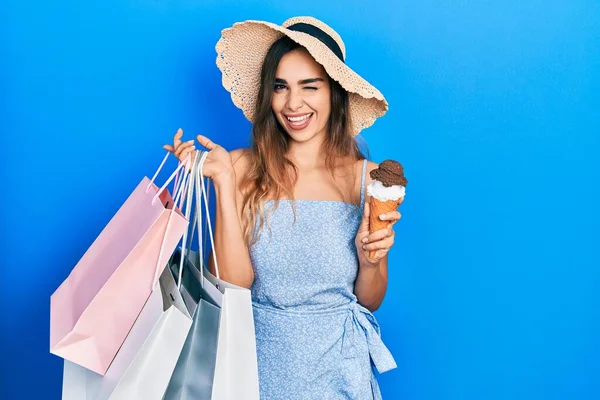Young Hispanic Girl Holding Shopping Bags Ice Cream Winking Looking — ストック写真