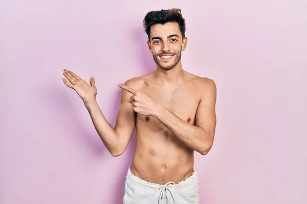 Young Hispanic Man Wearing Swimwear Shirtless Amazed Smiling Camera While — Stock Photo, Image