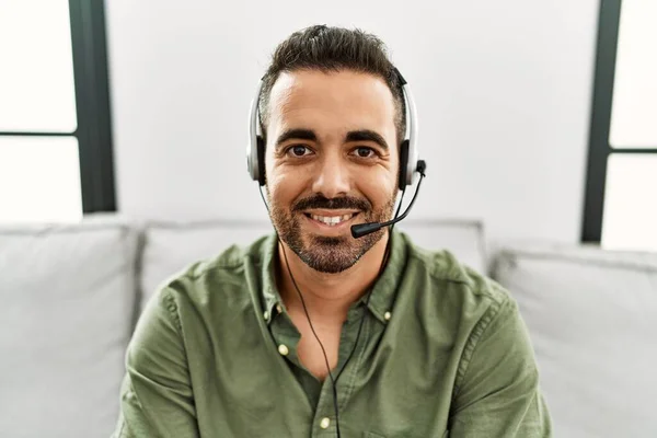 Young hispanic man call center agent working at home