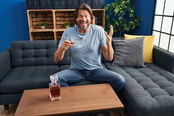 Handsome Middle Age Man Drinking Glass Whiskey Sitting Sofa Celebrating — Stock Photo, Image