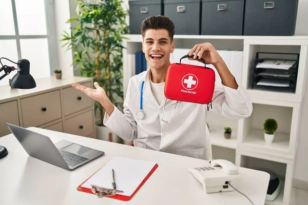 Young Hispanic Doctor Man Holding First Aid Kit Celebrating Achievement — Photo