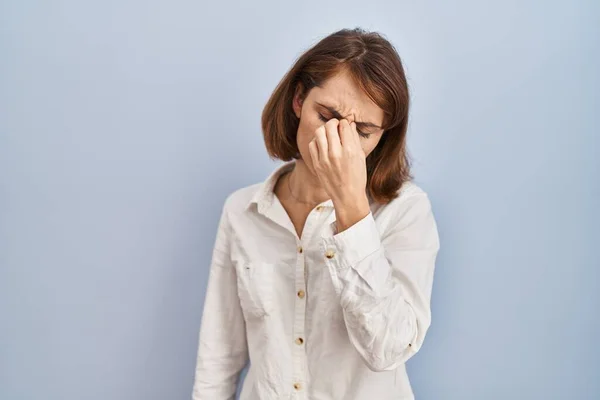 Young Beautiful Woman Standing Casual Blue Background Tired Rubbing Nose — Stockfoto