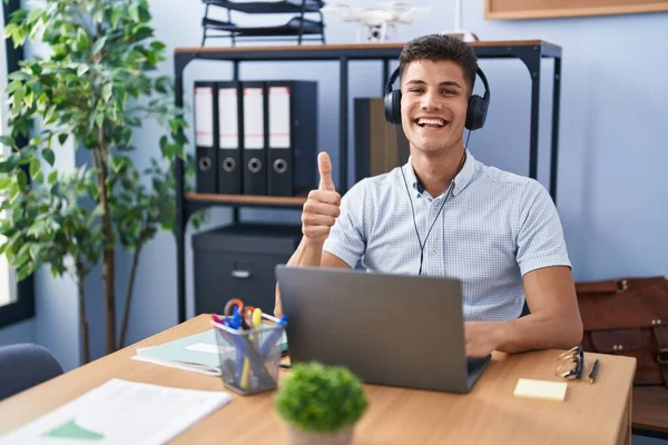 Young Hispanic Man Working Office Wearing Headphones Doing Happy Thumbs — Stockfoto
