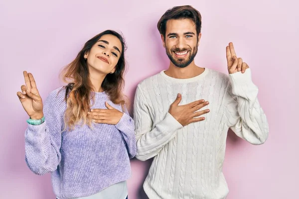 Young Hispanic Couple Wearing Casual Clothes Smiling Swearing Hand Chest — Fotografia de Stock